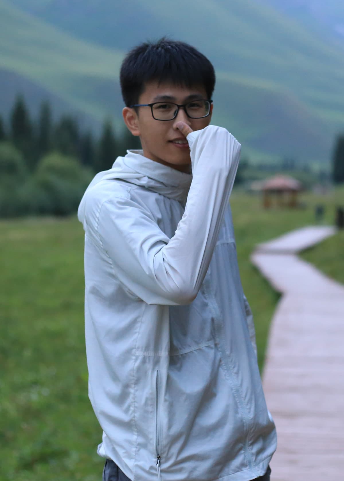 HappyDing, standing beside a mountain valley trail